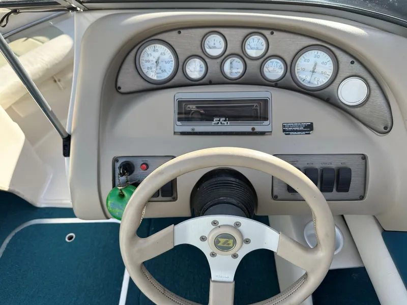Slide: The Image of Dashboard of a 1995 Larson 174 SEI boat with gauges and steering wheel. - 3