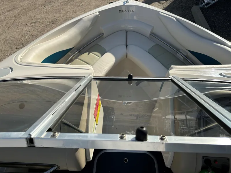 Slide: The Image of 1995 Larson 174 SEI boat interior with open windshield and seating area. - 4