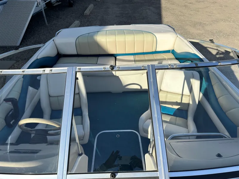 Slide: The Image of 1995 Larson 174 SEI boat interior with white and teal seating, viewed from above. - 6