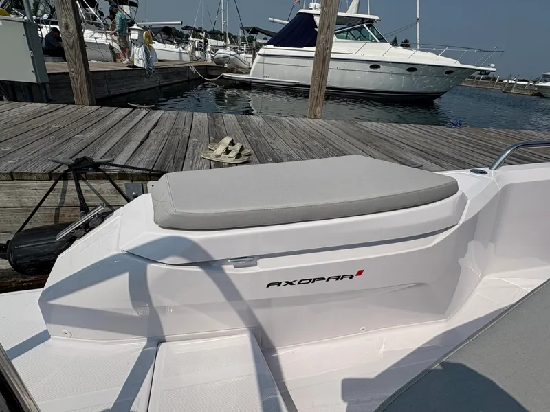 Slide: The Image of 2025 Axopar 29 XC Cross Cabin docked at marina, showcasing sleek design. - 15