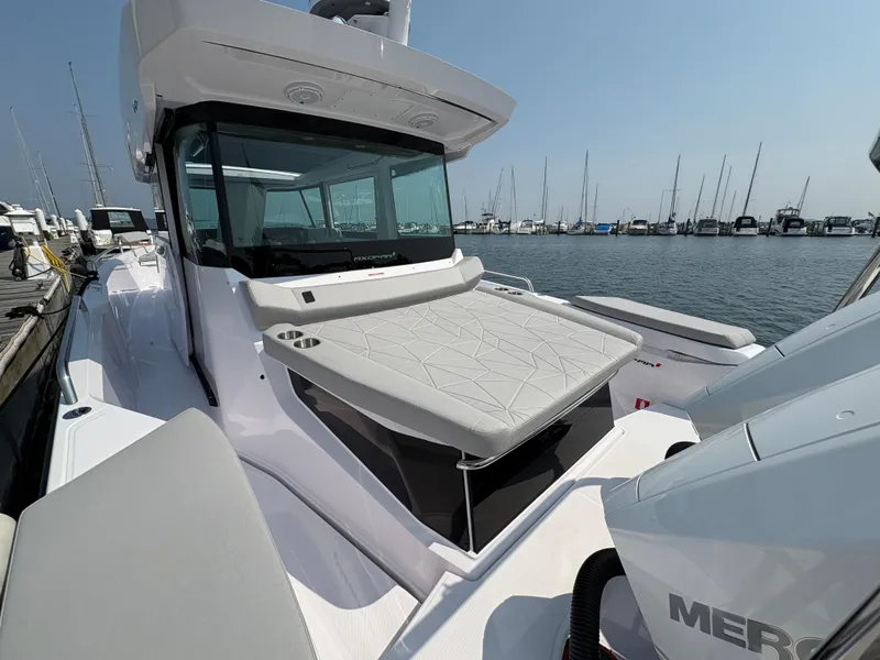 Slide: The Image of 2025 Axopar 29 XC Cross Cabin boat docked at marina, featuring sleek design and spacious deck. - 17