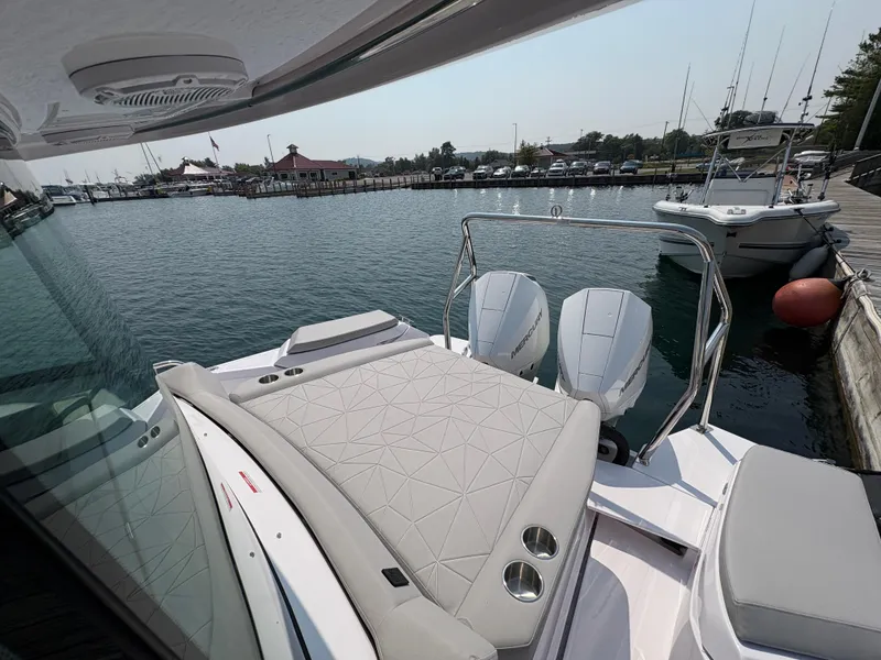 Slide: The Image of 2025 Axopar 29 XC Cross Cabin boat with twin Mercury engines docked at marina. - 19