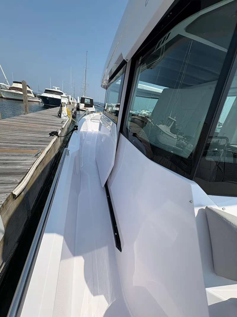 Slide: The Image of 2025 Axopar 29 XC Cross Cabin docked, showcasing sleek design and modern features. - 21