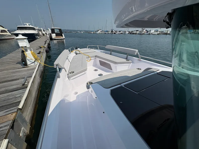 Slide: The Image of 2025 Axopar 29 XC Cross Cabin docked at a marina, showcasing sleek design and spacious deck. - 22