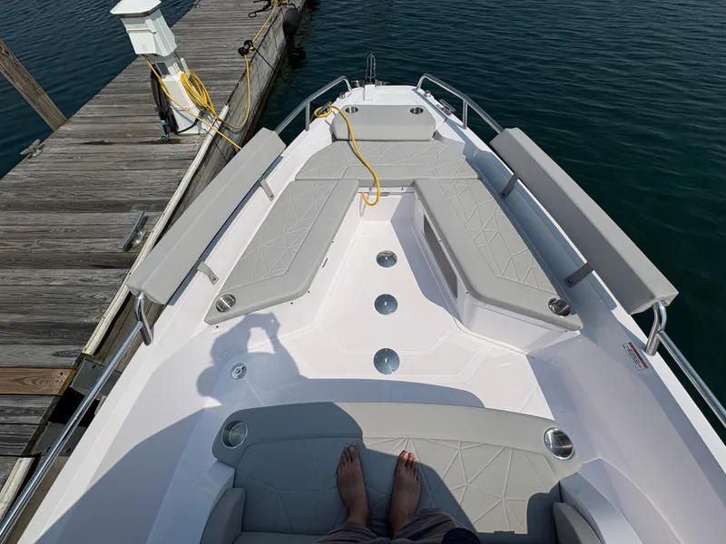 Slide: The Image of 2025 Axopar 29 XC Cross Cabin boat docked, featuring spacious seating and modern design. - 23