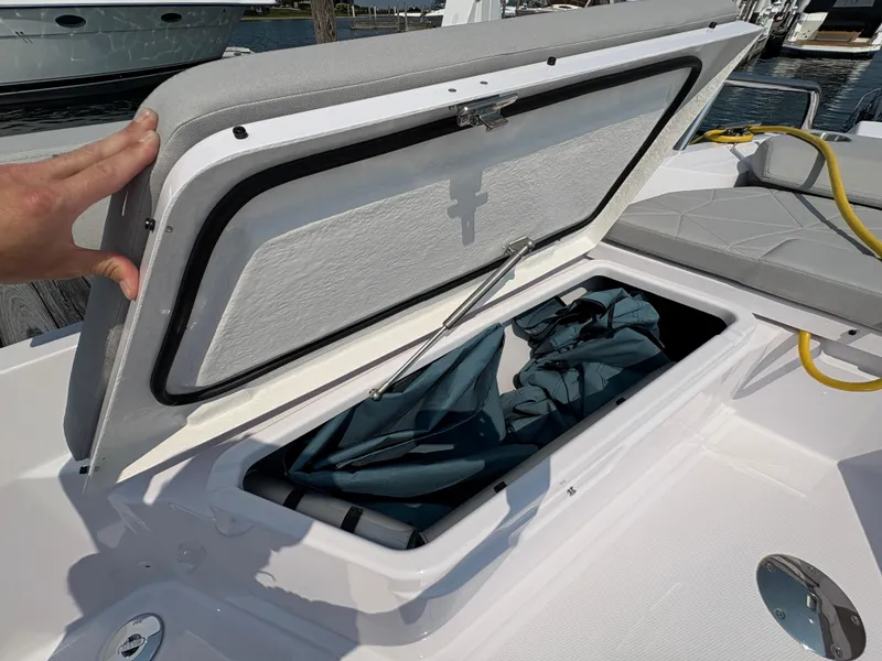 Slide: The Image of Open storage compartment on 2025 Axopar 29 XC Cross Cabin boat, showing interior space. - 28