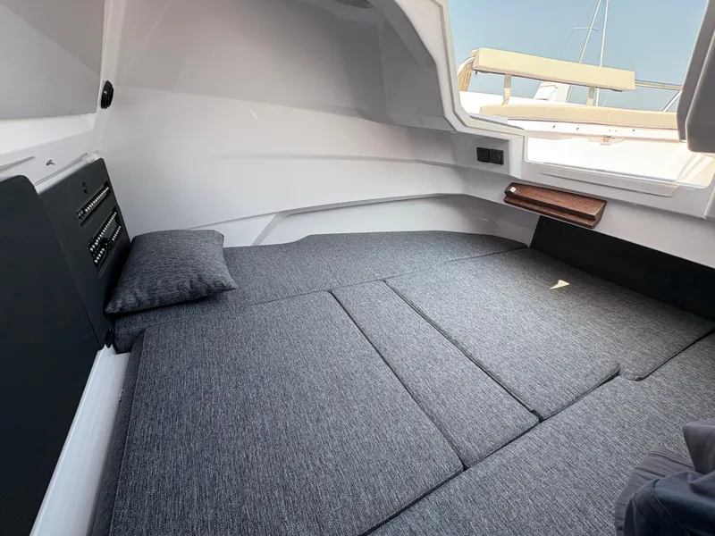 Slide: The Image of 2025 Axopar 29 XC Cross Cabin interior with gray cushioned sleeping area. - 33