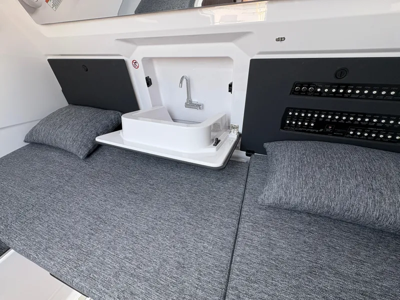 Slide: The Image of 2025 Axopar 29 XC Cross Cabin interior with sink and control panel. - 37