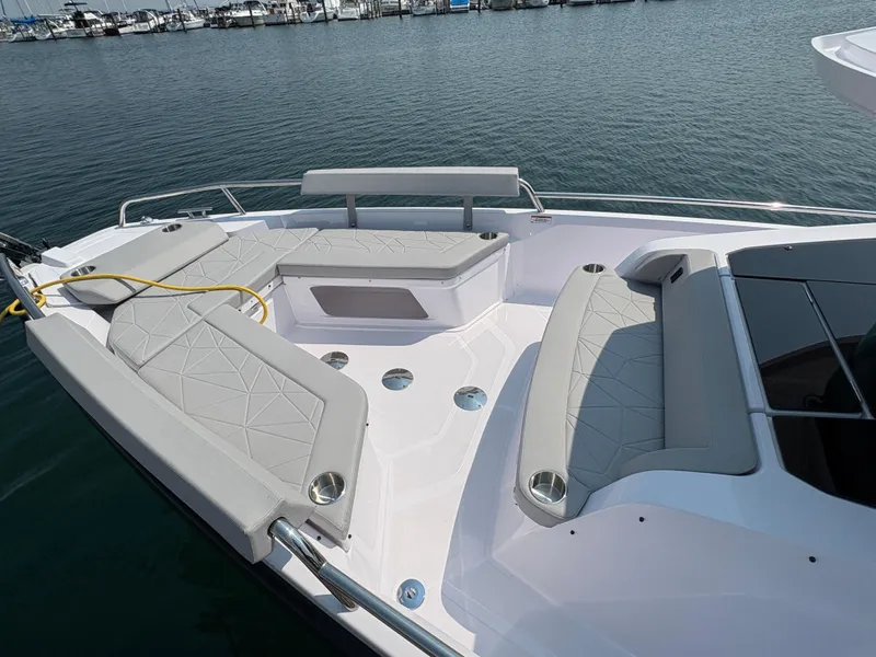 Slide: The Image of 2025 Axopar 29 XC Cross Cabin boat with spacious seating area on calm water. - 4