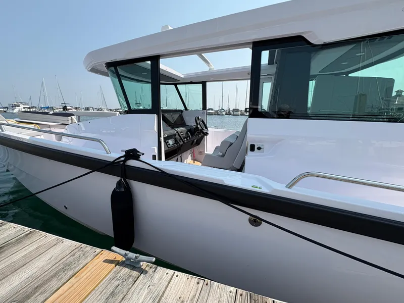 Slide: The Image of 2025 Axopar 29 XC Cross Cabin boat docked at marina, showcasing sleek design and modern features. - 43