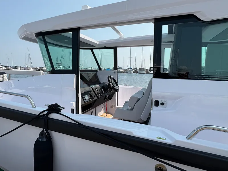 Slide: The Image of 2025 Axopar 29 XC Cross Cabin boat interior with marina view. - 44