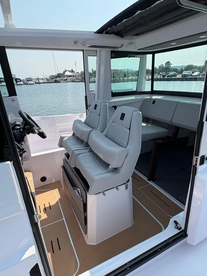 Slide: The Image of 2025 Axopar 29 XC Cross Cabin interior with modern seating and panoramic windows. - 45