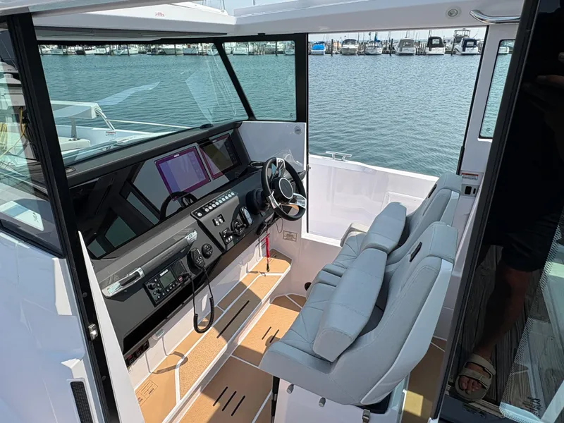 Slide: The Image of 2025 Axopar 29 XC Cross Cabin interior with modern dashboard and comfortable seating. - 46