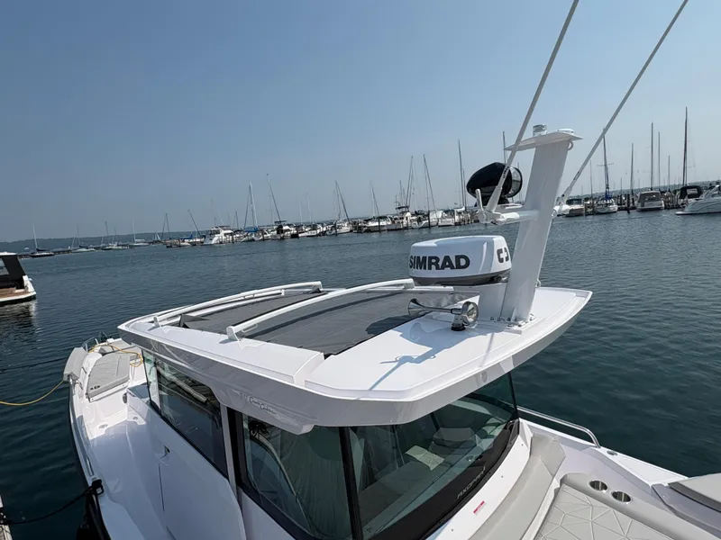 Slide: The Image of 2025 Axopar 29 XC Cross Cabin boat docked at marina with clear sky. - 8