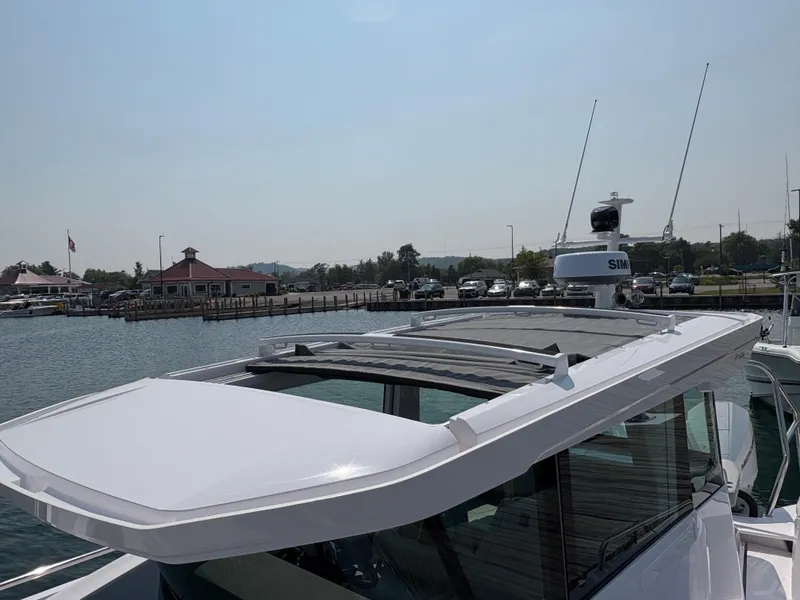 Slide: The Image of 2025 Axopar 29 XC Cross Cabin boat docked at a marina. - 9