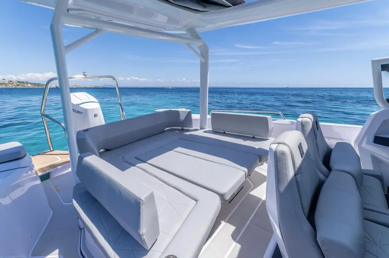 Slide: The Image of 2025 Axopar 29 Sun Top boat with spacious seating on a sunny day at sea. - 15