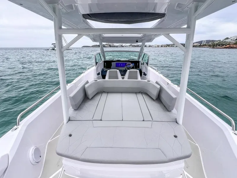 Slide: The Image of 2025 Axopar 29 Sun Top boat interior with spacious seating on open water. - 18