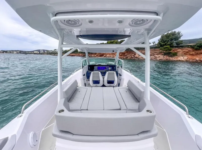 Slide: The Image of 2025 Axopar 29 Sun Top boat with spacious seating on calm waters. - 19