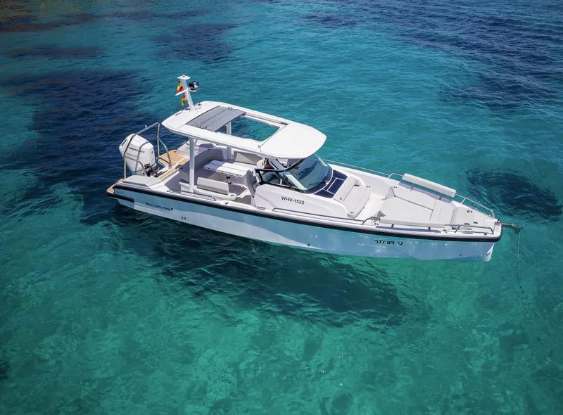 Slide: The Image of 2025 Axopar 29 Sun Top boat on clear turquoise water. - 2