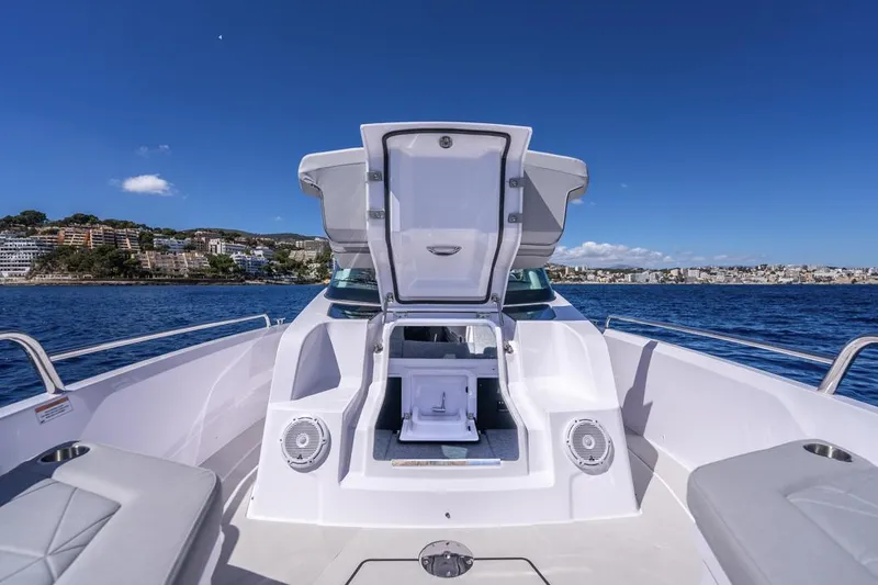Slide: The Image of 2025 Axopar 29 Sun Top boat with open storage, scenic ocean view. - 23