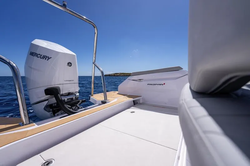 Slide: The Image of 2025 Axopar 29 Sun Top boat with Mercury engine on open water. - 28