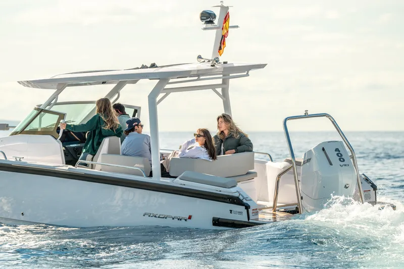 Slide: The Image of 2025 Axopar 29 Sun Top cruising with passengers on a sunny day. - 3