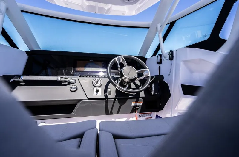 Slide: The Image of Interior view of 2025 Axopar 29 Sun Top boat cockpit with steering wheel. - 5
