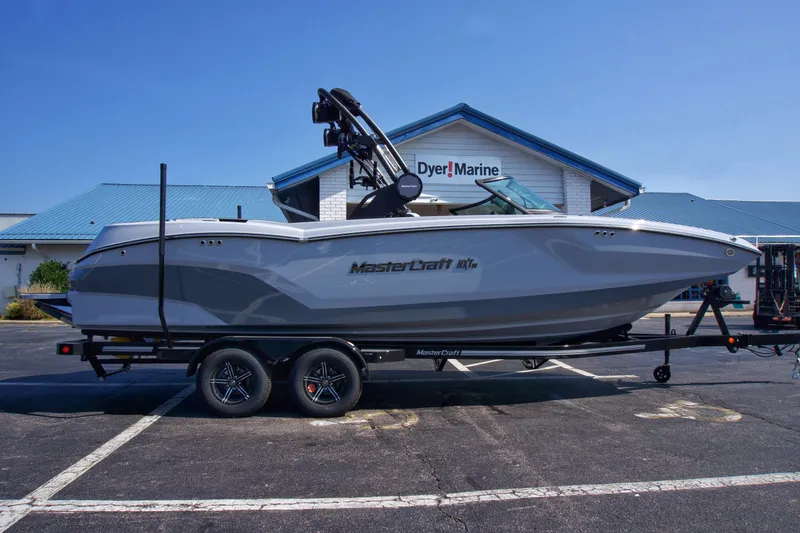 The Image of 2025 MasterCraft NXT24 boat on trailer at Dyer Marine dealership. - 1