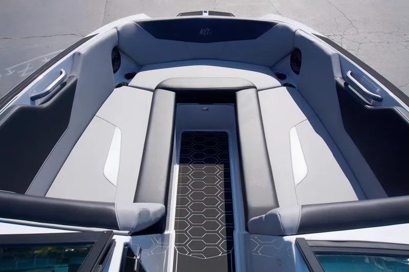Slide: The Image of 2025 MasterCraft NXT24 boat interior with sleek gray seating and hexagonal floor design. - 8