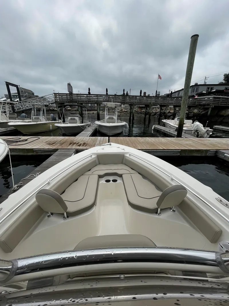 Slide: The Image of 2023 Key West 219 FS boat docked at marina under cloudy sky. - 2