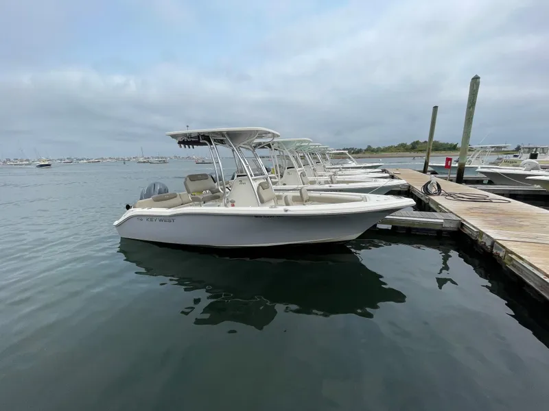 Slide: The Image of 2023 Key West 219 FS boat docked at marina under cloudy sky. - 4