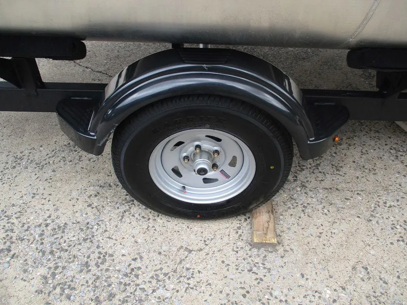 Slide: The Image of Trailer wheel of 2025 Sun Tracker PARTY BARGE® 16 DLX on concrete surface. - 10