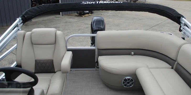 Slide: The Image of 2025 Sun Tracker PARTY BARGE® 16 DLX interior with beige seating and steering wheel. - 11