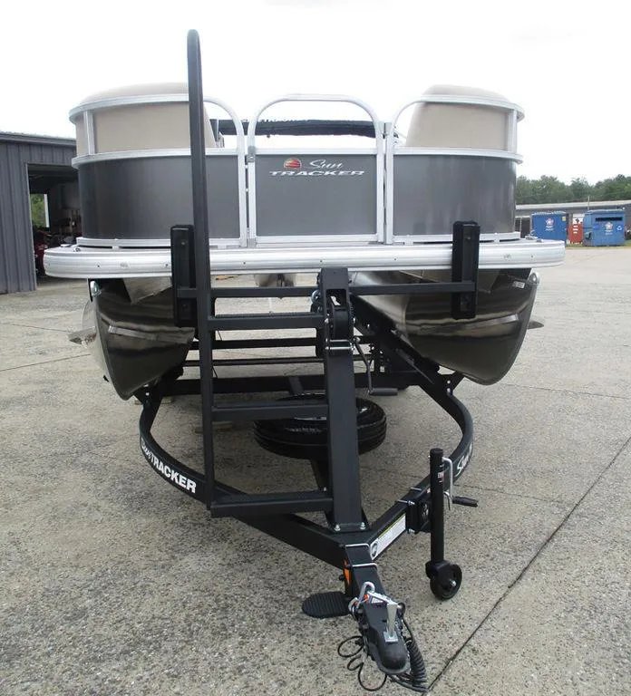 Slide: The Image of 2025 Sun Tracker PARTY BARGE® 16 DLX pontoon boat on trailer, front view. - 12