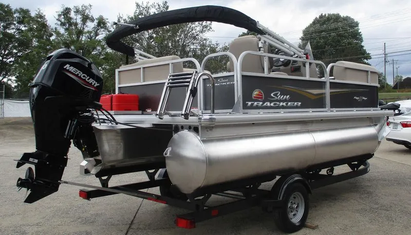 Slide: The Image of 2025 Sun Tracker PARTY BARGE® 16 DLX pontoon boat on trailer, featuring Mercury outboard motor. - 3