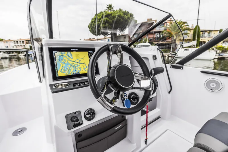 Slide: The Image of 2025 Axopar 25 Cross Top boat interior with plush seating and modern design. - 10