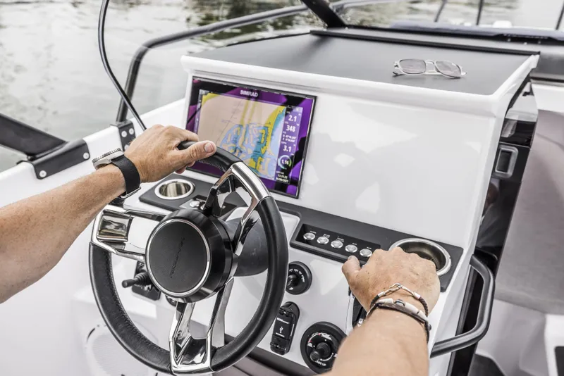 Slide: The Image of 2025 Axopar 25 Cross Top boat interior roof view at a showroom. - 11