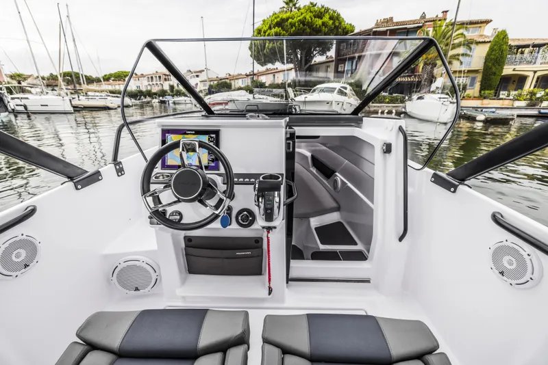 Slide: The Image of Steering console of 2025 Axopar 25 Cross Top boat with modern controls and display. - 8