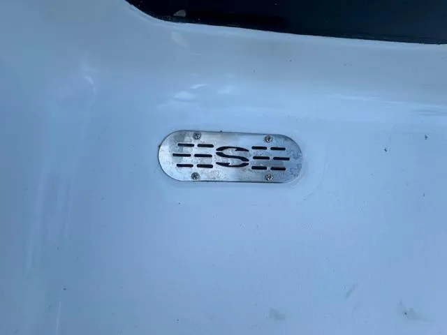 Slide: The Image of 2025 Sportsman Masters 247 Bay Boat metal emblem on white surface. - 16