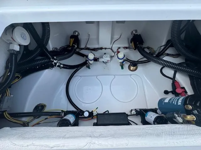 Slide: The Image of 2025 Sportsman Masters 247 Bay Boat wiring and plumbing compartment. - 18