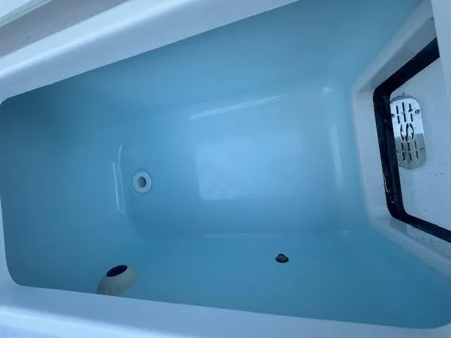 Slide: The Image of Livewell compartment in 2025 Sportsman Masters 247 Bay Boat, featuring clean design and drainage. - 19