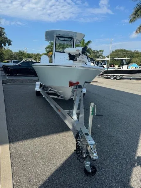 Slide: The Image of 2025 Sportsman Masters 247 Bay Boat on trailer, parked outdoors under a clear sky. - 2