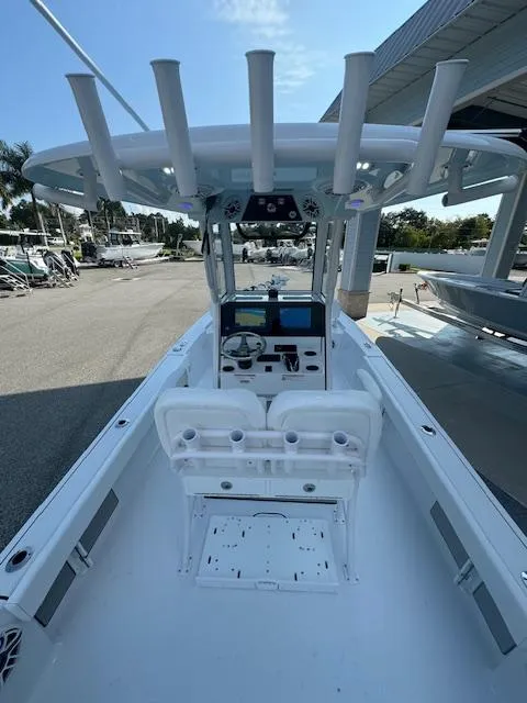 Slide: The Image of 2025 Sportsman Masters 247 Bay Boat with T-top and dual seating, docked outdoors. - 21