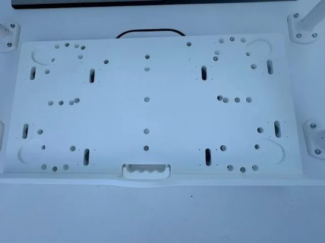 Slide: The Image of Mounting plate on 2025 Sportsman Masters 247 Bay Boat, featuring multiple drilled holes. - 24