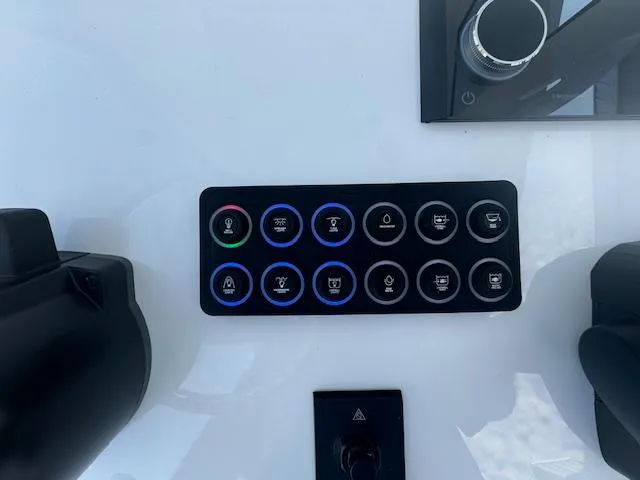 Slide: The Image of Control panel of 2025 Sportsman Masters 247 Bay Boat with illuminated buttons. - 27