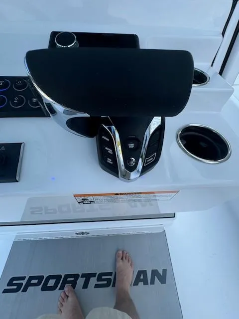 Slide: The Image of 2025 Sportsman Masters 247 Bay Boat console with controls and cup holders. - 28