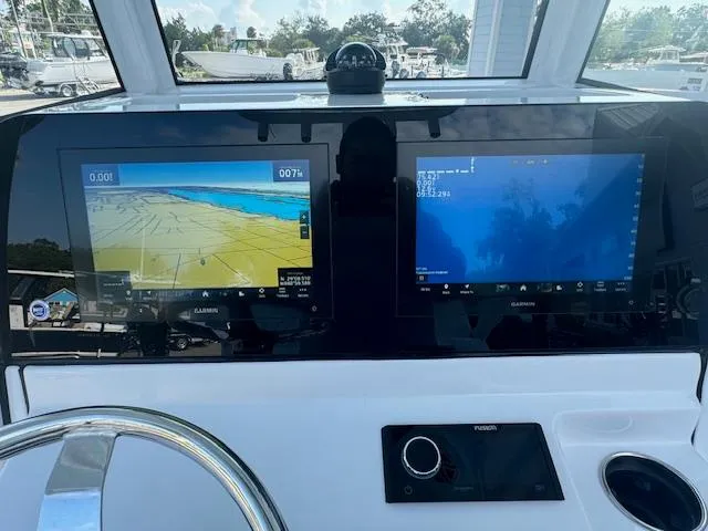 Slide: The Image of Dashboard of 2025 Sportsman Masters 247 Bay Boat with dual Garmin displays. - 30