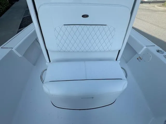 Slide: The Image of 2025 Sportsman Masters 247 Bay Boat interior with white cushioned seating. - 34