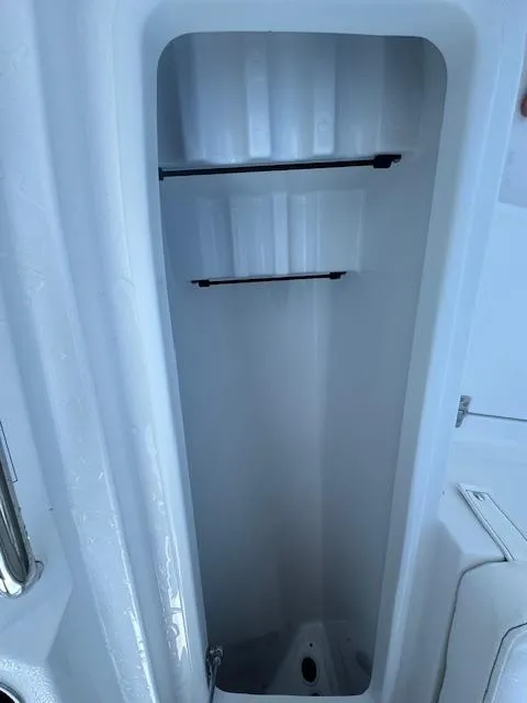 Slide: The Image of 2025 Sportsman Masters 247 Bay Boat storage compartment, open and empty. - 4