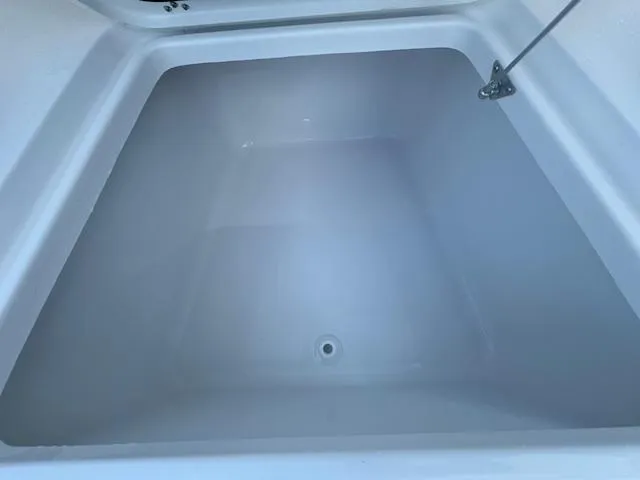 Slide: The Image of 2025 Sportsman Masters 247 Bay Boat storage compartment, open lid, spacious interior. - 5